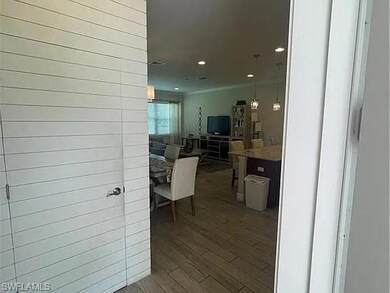 Corridor with wood finished floors and recessed lighting