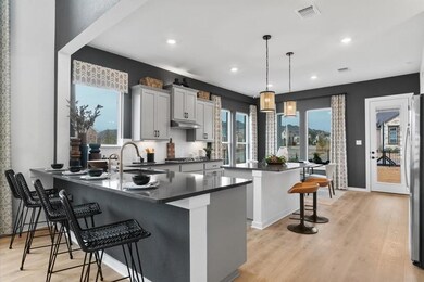 Kitchen featuring dark countertops, a sink, a bre