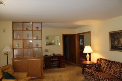 Living room with front entrance to left and dining room to the right.