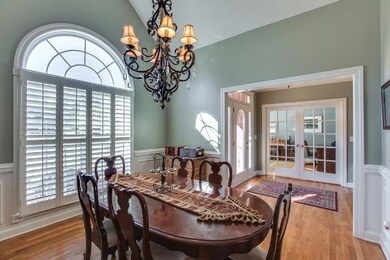The Formal DIning Room features a palladian window and wainscotting