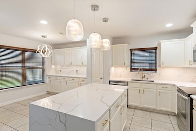 Kitchen featuring sink, backsplash, and pendant lighting