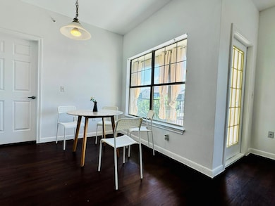 Dining area with baseboards and dark wood-style f