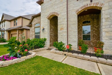The brick and stone craftsmanship to the exterior of the home is so reminiscent of the work of old world artisans and masons! Your covered front entry is generous. It also affords privacy, shelter from the elements and room enough for home deliveries and happy guests!