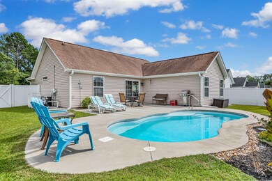 View of pool with grilling area, a yard, and a pat