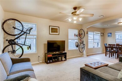 Carpeted living room with baseboards, visible ven