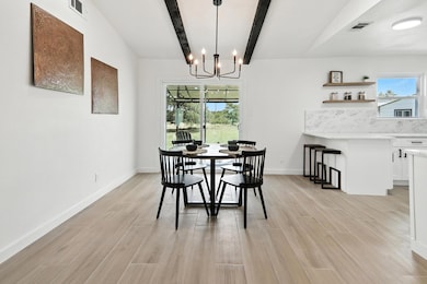 Dining area with a chandelier, light wood-type fl