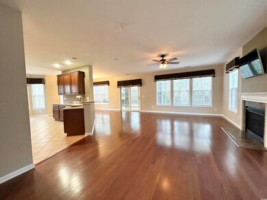 Unfurnished living room with dark wood-style floor