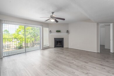 Large living room with wood burning fireplace. The