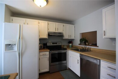 Kitchen with pass through window to dining and liv