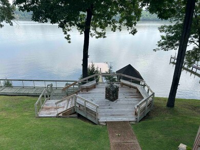 Dock area featuring a water view and a yard