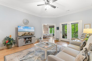Living room featuring ornamental molding, wood fin