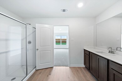 Bathroom with light wood finished floors, vanity, recessed lighting, and a stall shower