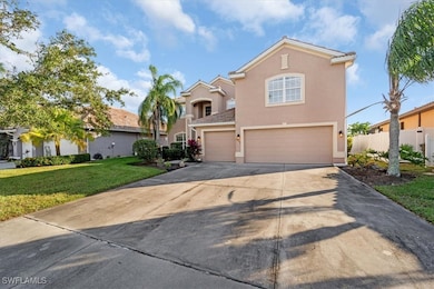 View of front of home with a front lawn and a gara