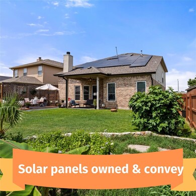Back of house featuring solar panels, a patio are