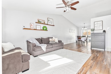 Bright and inviting living room abundant natural light and  LVP flooring ceiling fan.