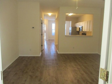 Spare room with wood finished floors and baseboards