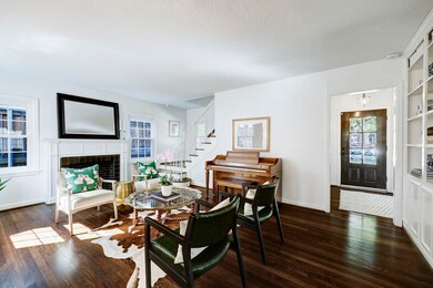 Light filled formal living room with view to stair