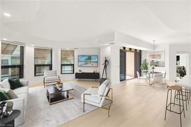 Living room with light wood-style floors, recessed lighting, arched walkways, plenty of natural light, and a tray ceiling (Virtually Staged)