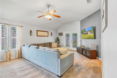 Living room featuring vaulted ceiling, carpet floo