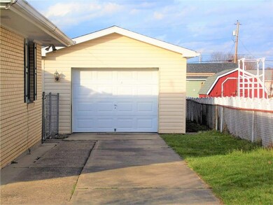 There's an oversized single garage with front and 