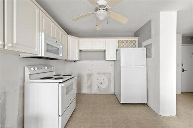 Kitchen with light tile patterned floors, ceiling 