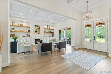 Living room featuring coffered ceiling, beamed cei