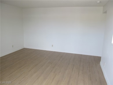 Spare room with light wood finished floors and bas