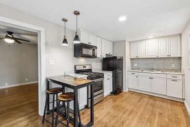 Kitchen with decorative light fixtures, light hard