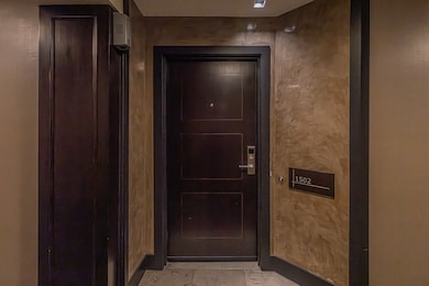 Entryway featuring light marble finish flooring and baseboards