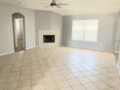 Unfurnished living room featuring arched walkways,