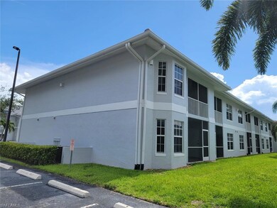 View of side of home with stucco siding, uncovered parking, and a lawn