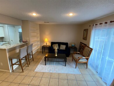 This living area features tile flooring, seating a