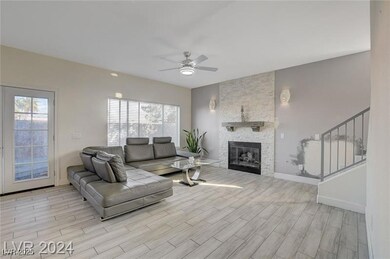Living area featuring a ceiling fan, wood finished