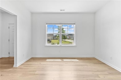 Spare room featuring light wood-style flooring