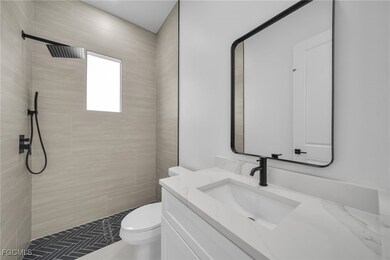 Bathroom with vanity and a tile shower