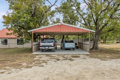 View of parking / parking lot with a detached car