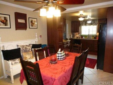 Tiled dining room and kitchen. Crown molding, ceiling fan remains.