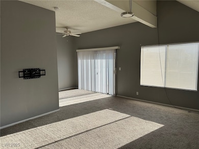 Carpeted empty room with ceiling fan and a texture