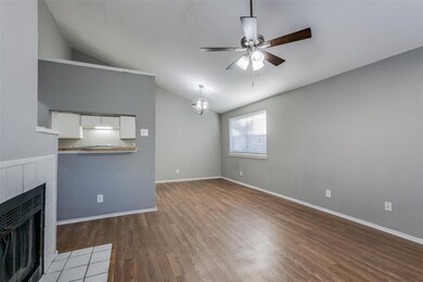 Living room with ceiling fan, a fireplace, wood-ty