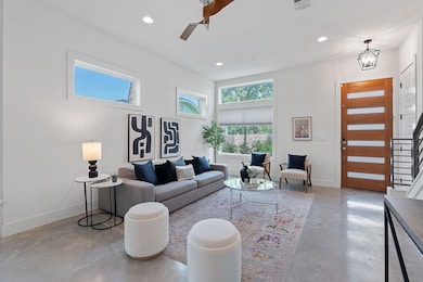 Living area featuring concrete flooring, a ceilin