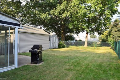The fully fenced yard with enclosed patio, grill w