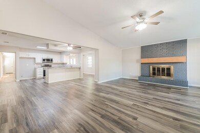 Unfurnished living room featuring sink, lofted cei