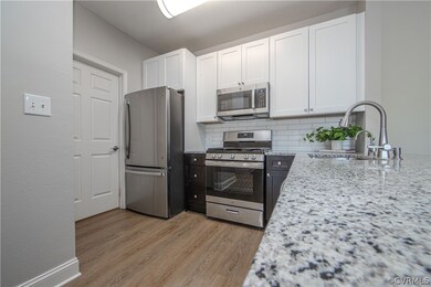 RENOVATED Kitchen with wood cabinetry, tile backsp