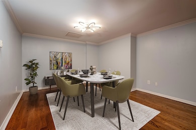 Dining area featuring ornamental molding, visible 