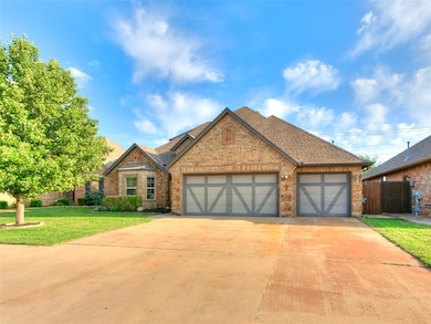 View of front of house featuring a shingled roof, a garage, concrete driveway, and brick siding