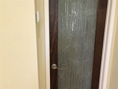 Custom glass doors in coat closet and guest powder