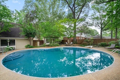 View of swimming pool with a fenced backyard and a diving board