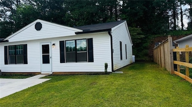 Bungalow featuring fence and a front lawn