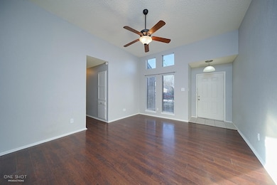 Unfurnished room with ceiling fan, a textured ceiling, and dark hardwood / wood-style floors