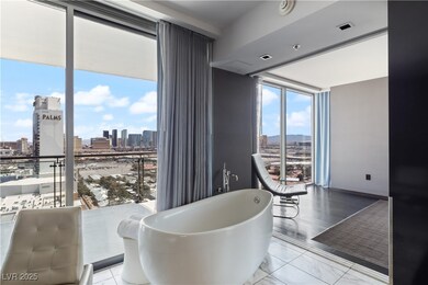 Dining space featuring a skyline view, a wall of w